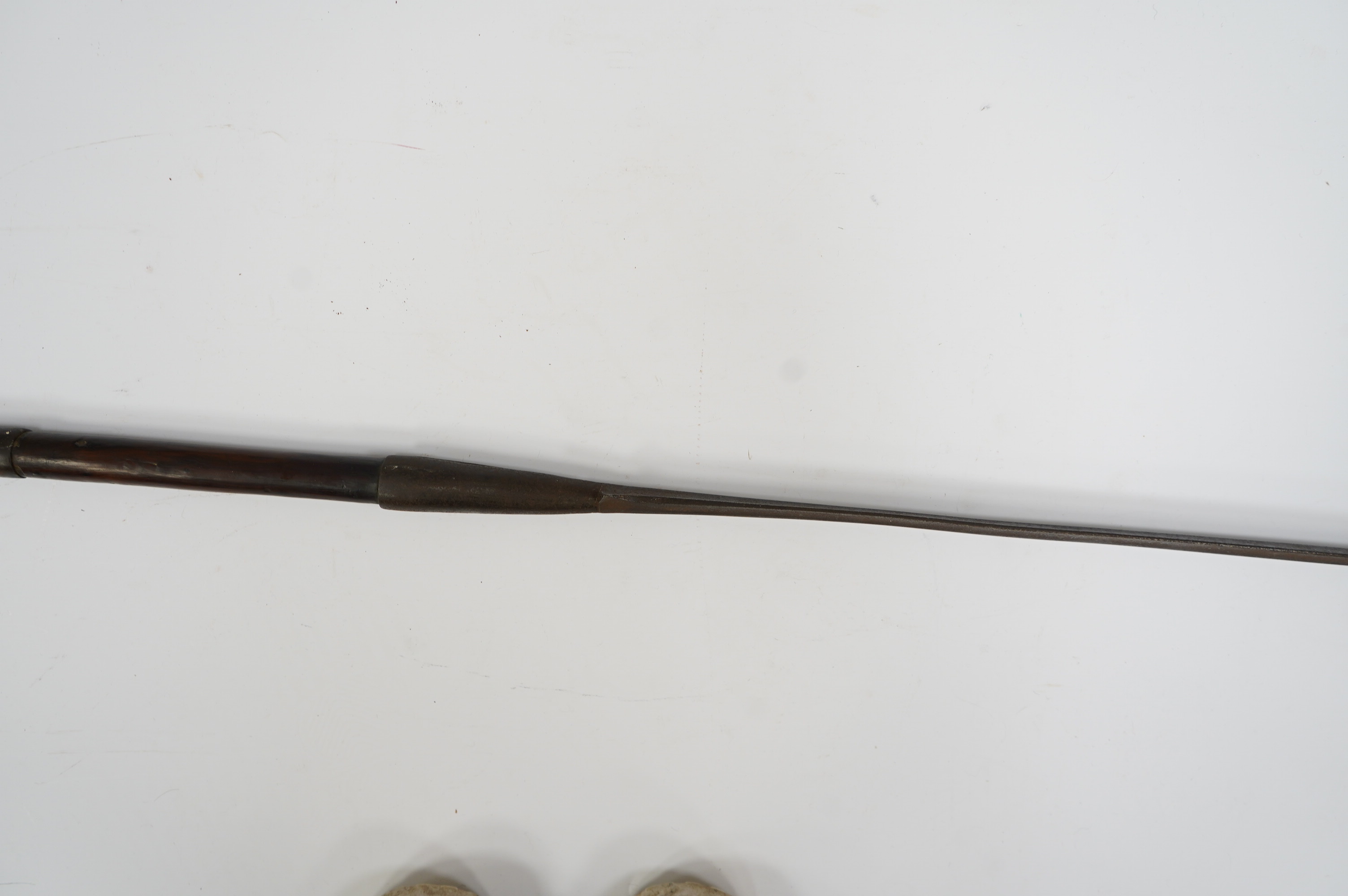 An African spear, with elongated iron tip and short hardwood shaft, 185cm. Condition fair to good, with patination.